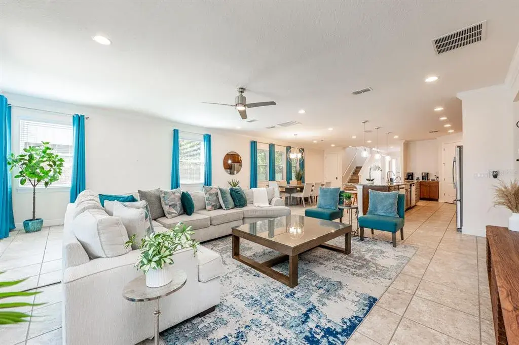 The Living Room features a striking picture-frame accent wall and sliding glass doors that open to your PRIVATE OUTDOOR OASIS.