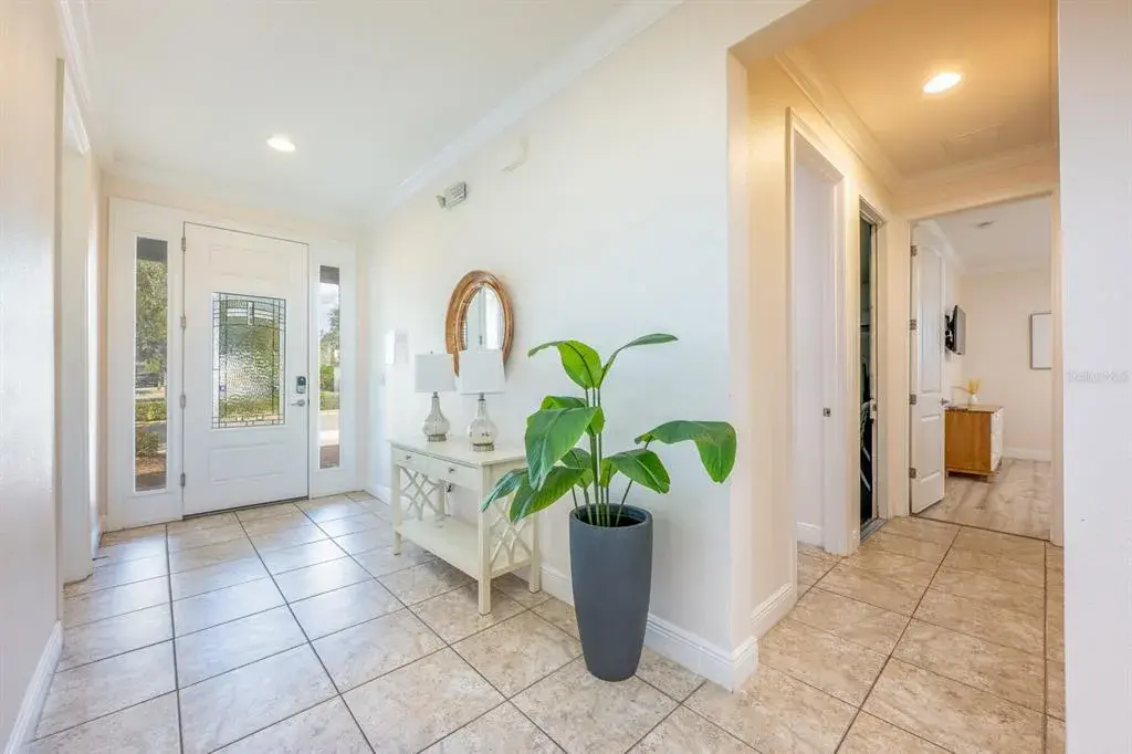 The expansive open-concept main floor seamlessly blends the Living Room, Dining area, and CHEF'S KITCHEN into one grand gathering space — ideal for hosting large groups with ease.