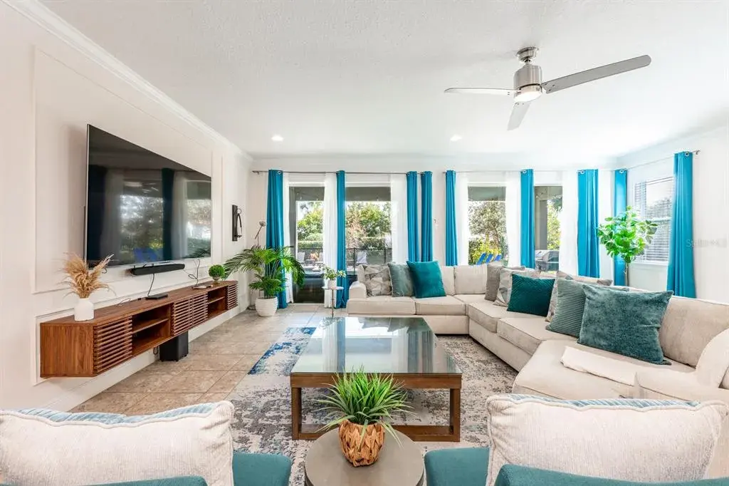 The Living Room features a striking picture-frame accent wall and sliding glass doors that open to your PRIVATE OUTDOOR OASIS.