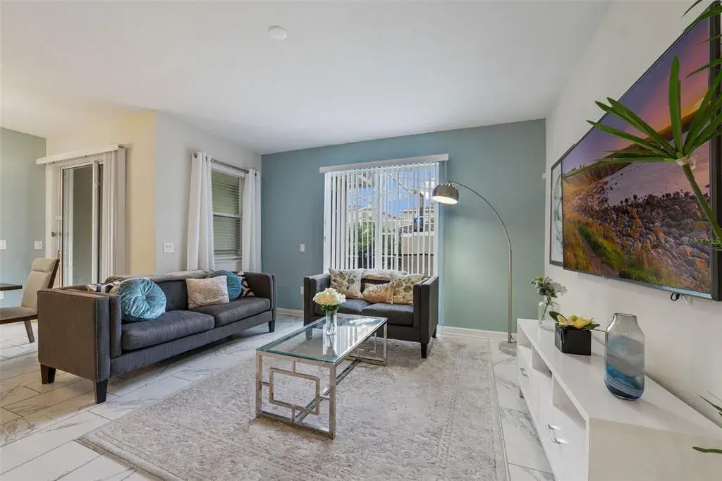 The main living spaces feature beautiful MARBLE-LOOK CERAMIC TILE FLOORING throughout, creating an elegant and easy-to-maintain living space.