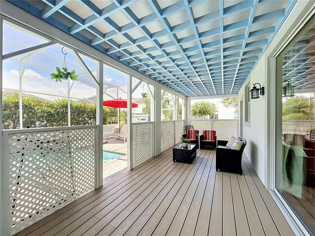 Covered lanai with upgraded wood flooring / wood ceiling accents.