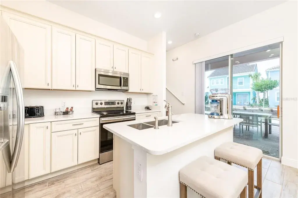 Open concept kitchen with quartz countertops and stainless steel appliances in Margaritaville Resort Orlando