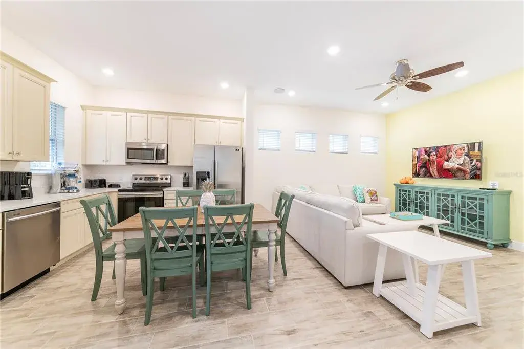 Open kitchen and dining with stainless appliances in Margaritaville Resort Orlando near Disney