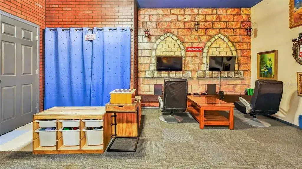 Harry Potter–themed garage conversion featuring a game room and hidden closet behind purple curtains.