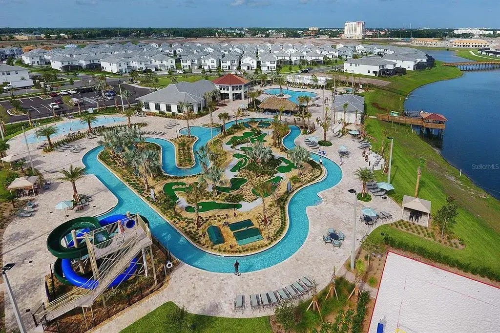 Storey Lake Resort Hideaway Clubhouse featuring laxy river, splash pad, tiki bar, ice cream shop, arcade, full commercial grade gym, waterslide, putt-putt golf, cabanas, and more!