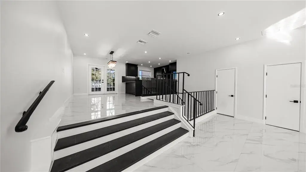 The neighbor enclosed the lower level, creating two additional bedrooms.