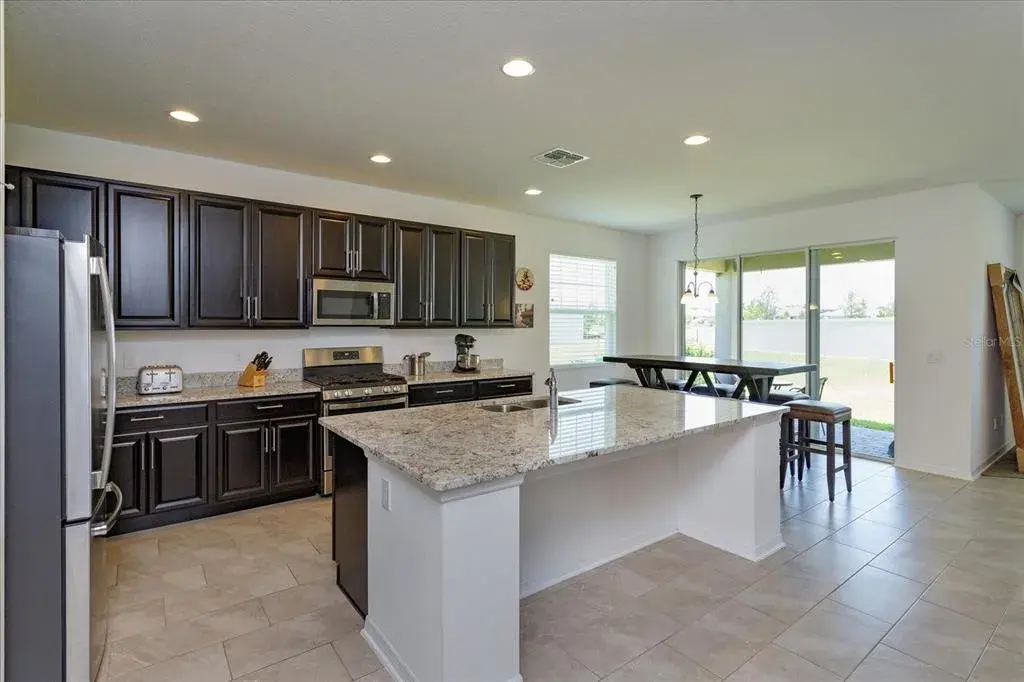 Gourmet kitchen with gas range, granite counters, 42 in cabintets