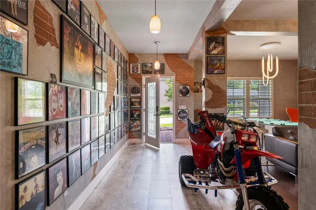 Welcoming foyer, formal living and dining spaces feature custom faux brick and textured wall finishes created by an artist who contributed to the Wizarding World attractions at Universal Orlando.