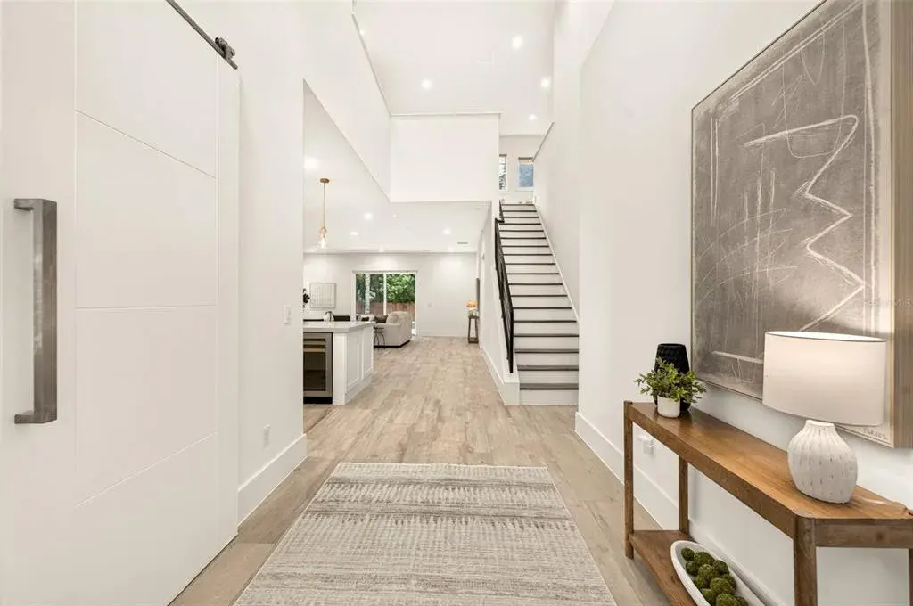 Foyer/entrance greets with 20-ft ceilings