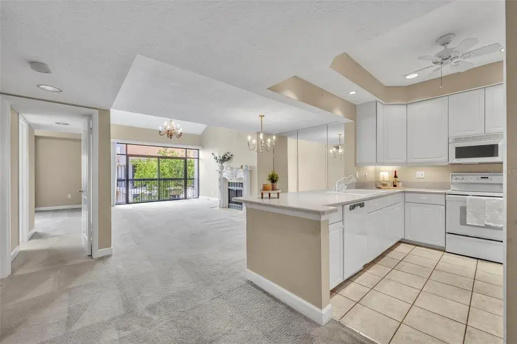 Vaulted ceilings, a wood-burning fireplace, and expansive windows give a hint of how remarkable this condo is.