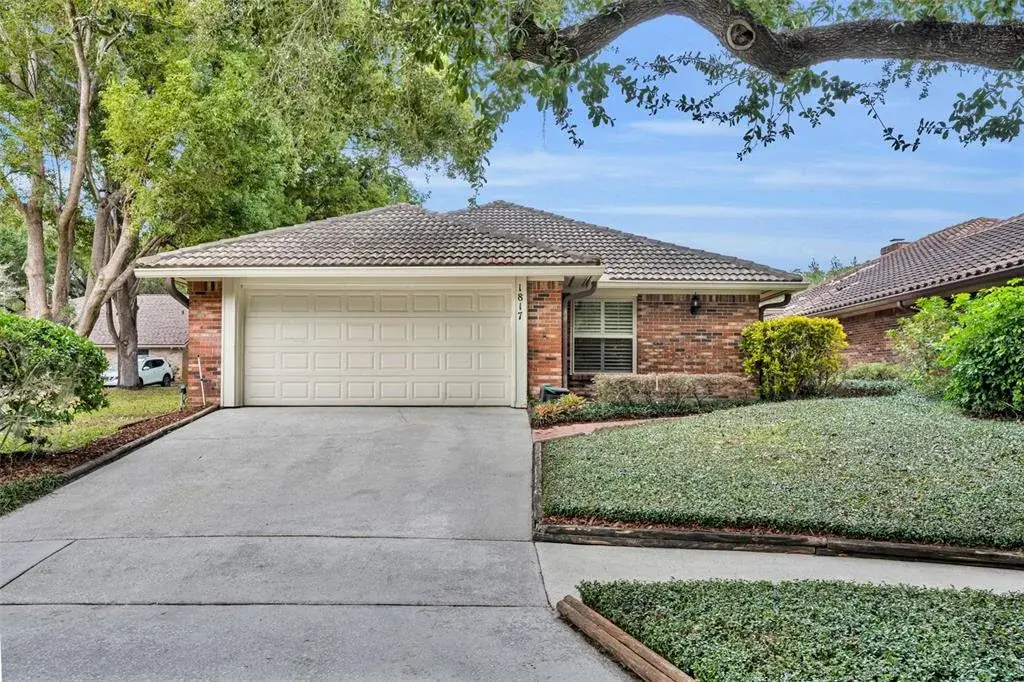 Well maintained brick exterior with a spacious two car garage, mature landscaping, and welcoming curb appeal.