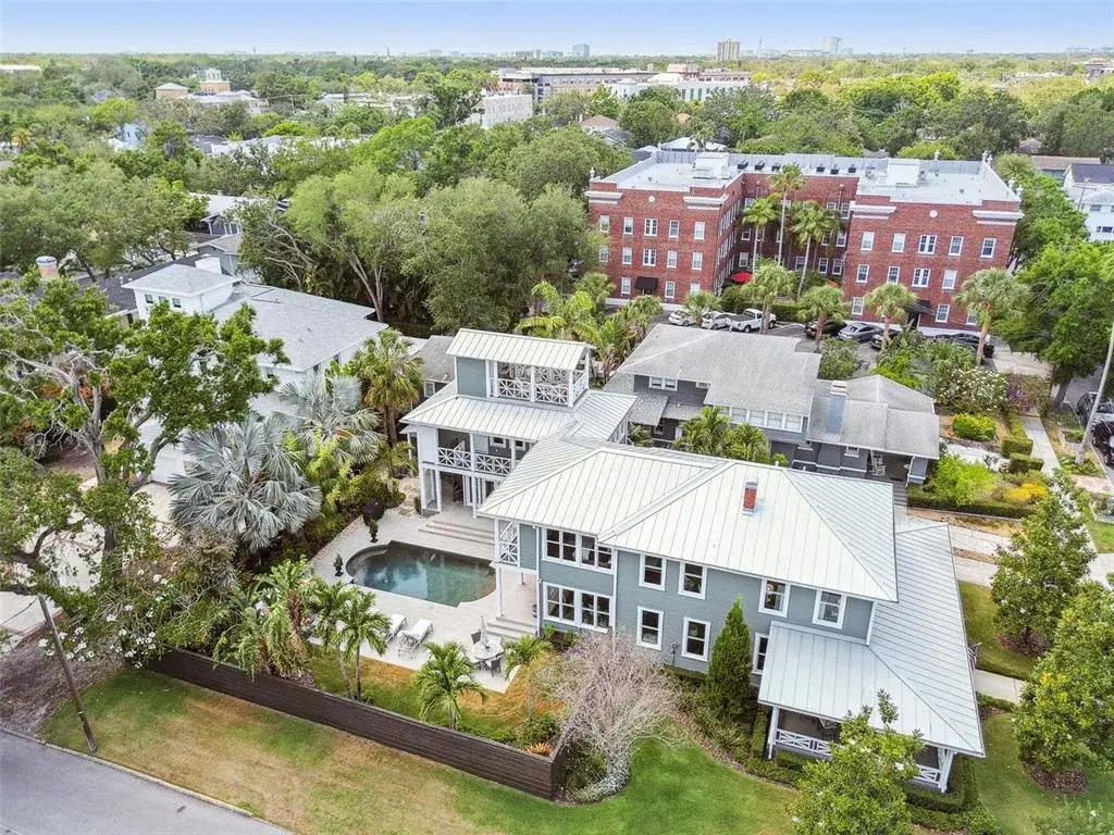 Note the Widow's Walk atop the Guest Wing. Fencing and foliage create back yard privacy.