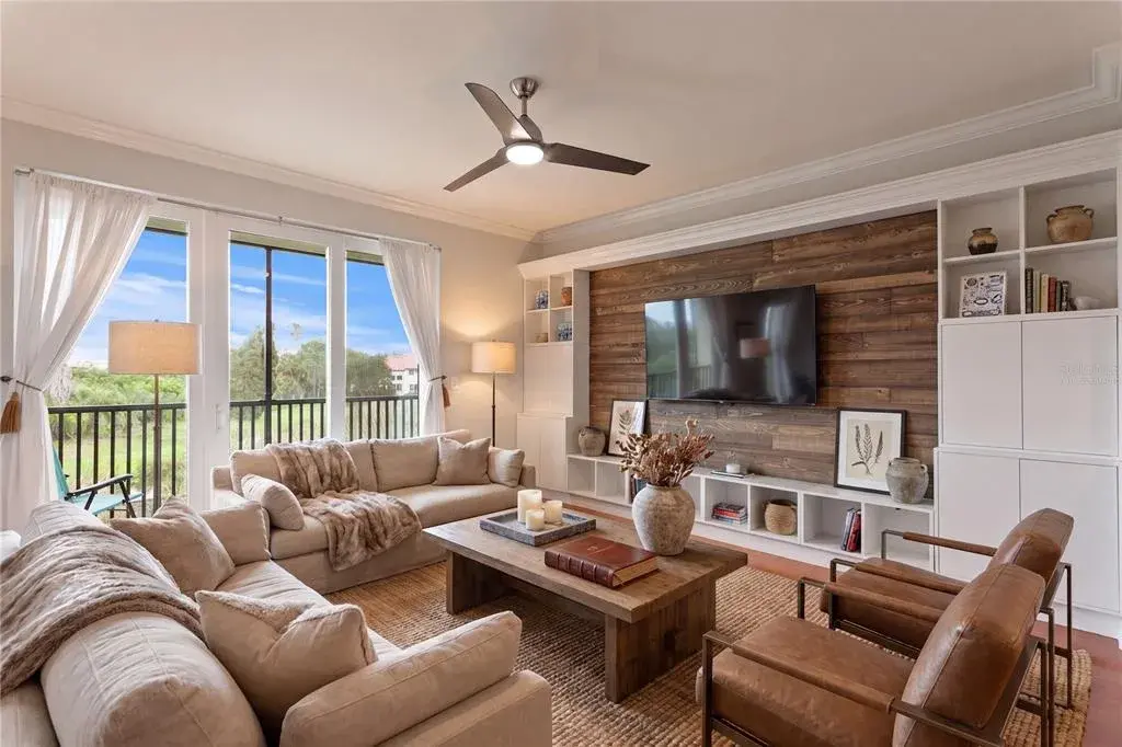 Virtually staged image - The spacious great room features a custom feature wall with built-ins, creating warmth and an idealbackdrop for your television.