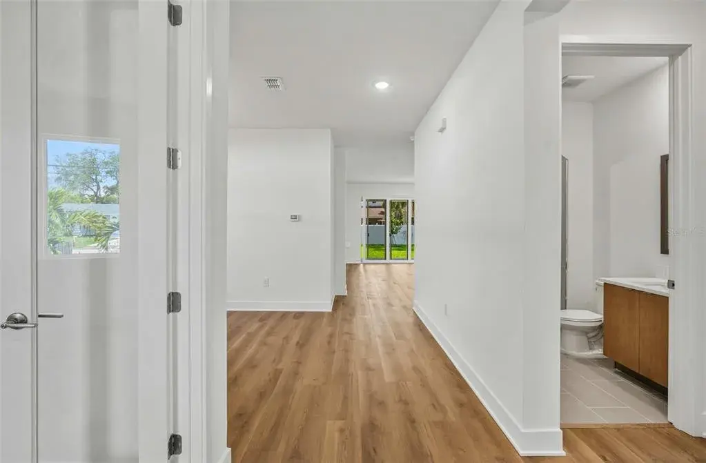 Front entry looking at den and first floor bathroom and bedroom