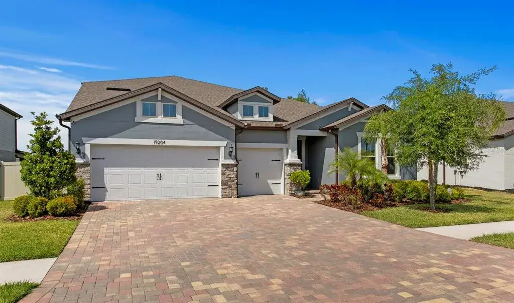 Front of the Home with Pavered Driveway and 3 Car Garage