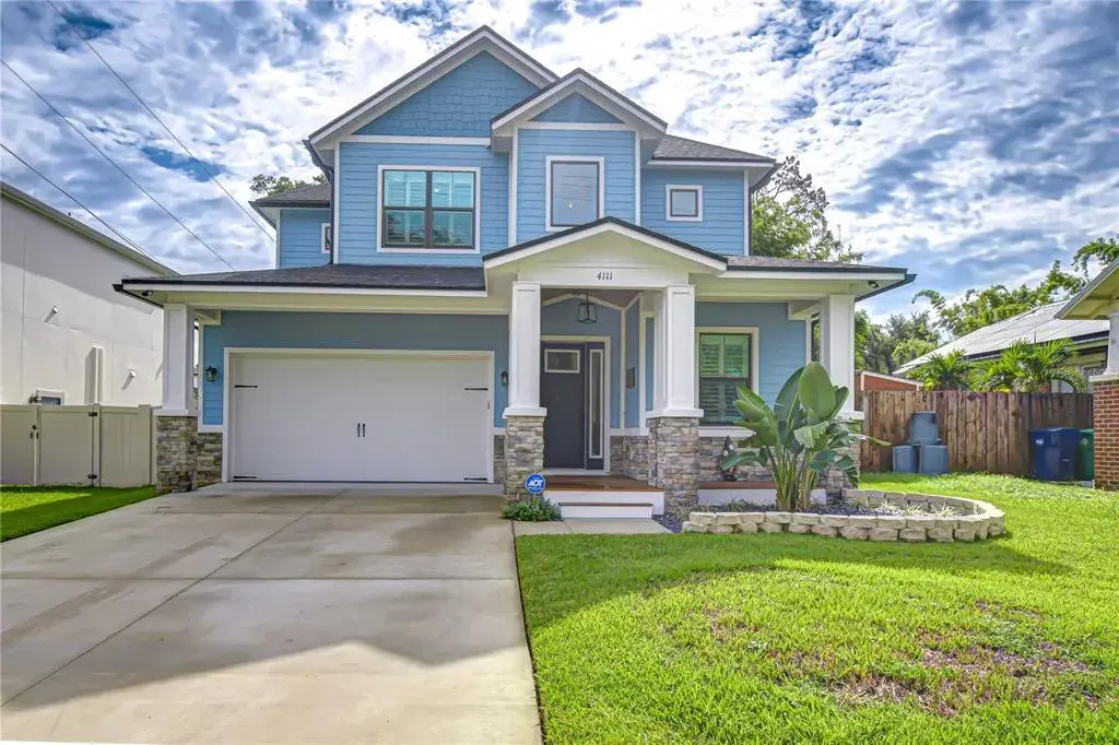 Stacked stone accents and charming architectural details enhance the home’s curb appeal.