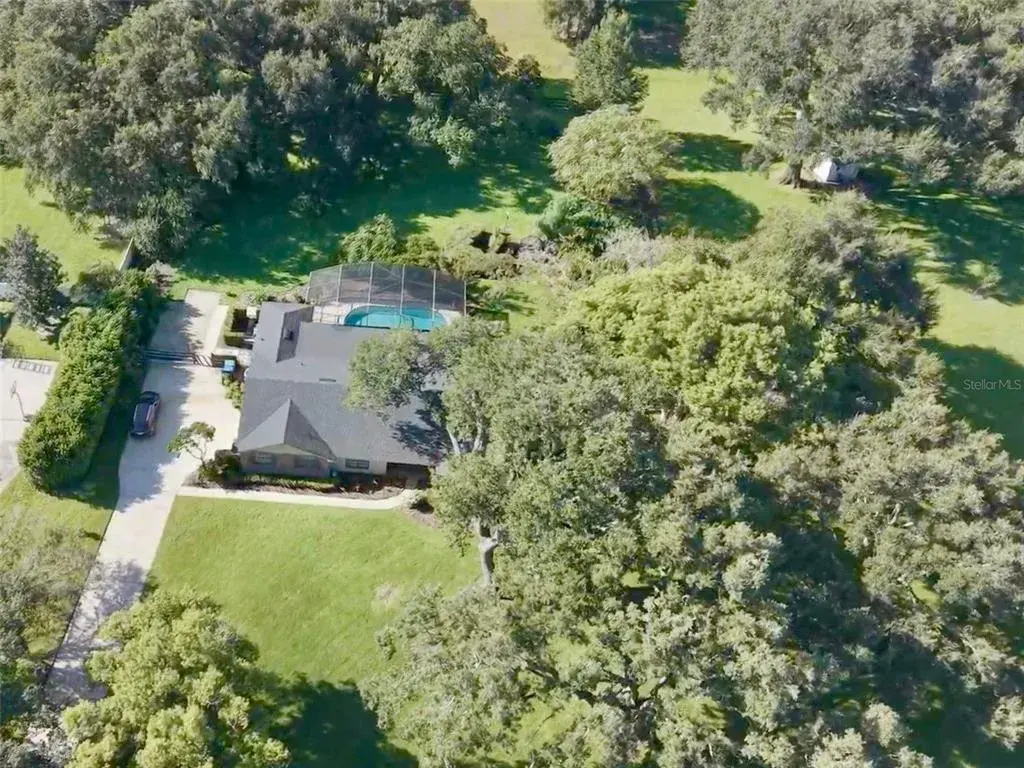 Pool home on over 1-acre lot with beautiful, mature approx 100-year-old oak trees.