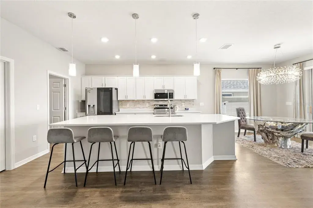 Oversized island, upgraded lighting and stainless appliances