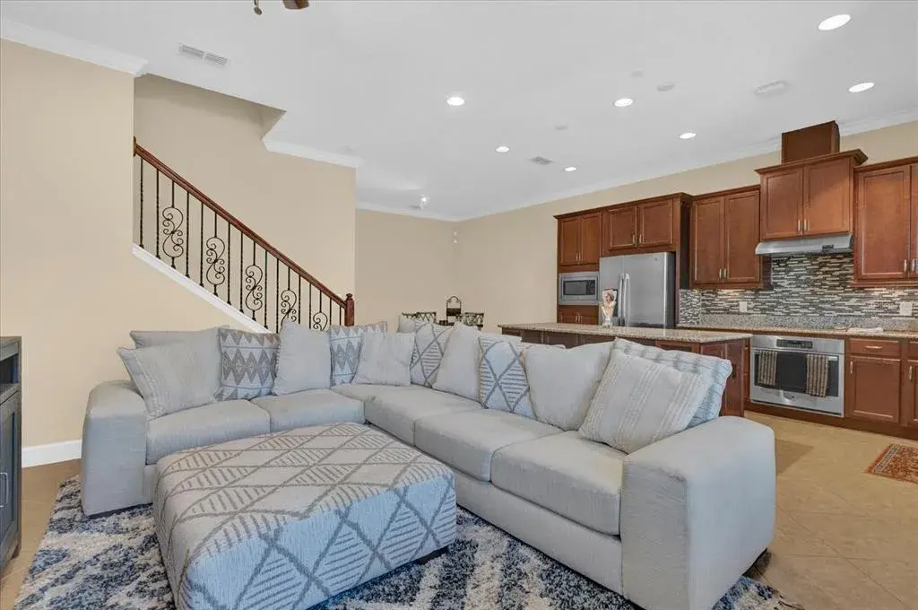 Spacious open-concept living room with an oversized sectional, ideal for entertaining.