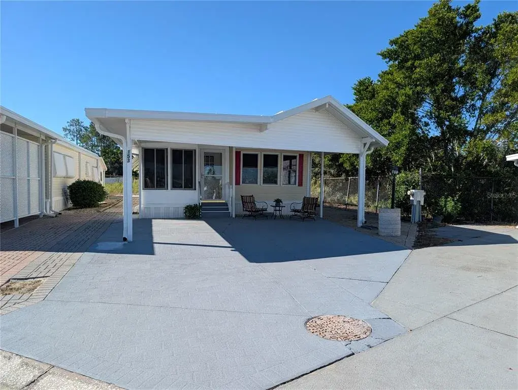FRONT SHOWING GREY DRIVE WAY