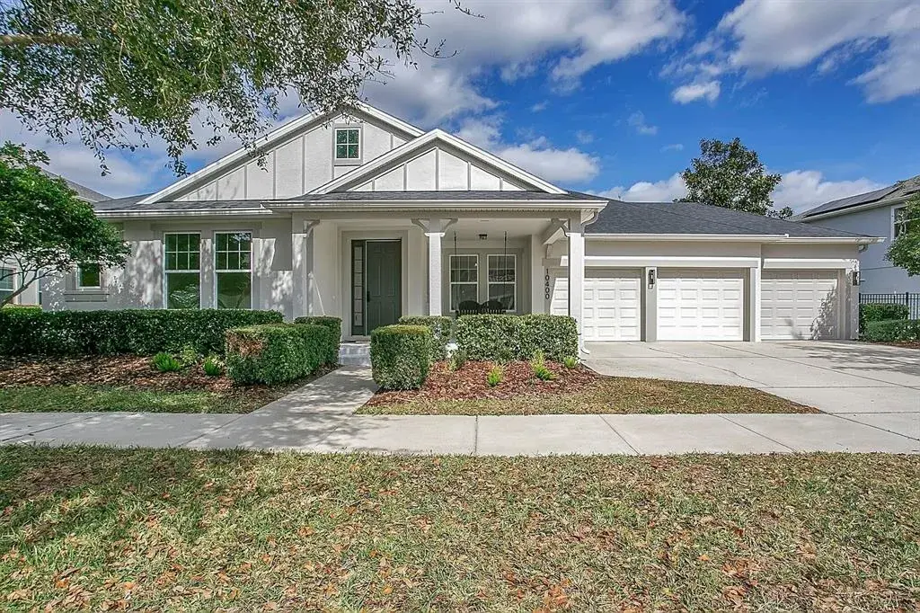 Front view with spacious 3 car garage, front porch with swing