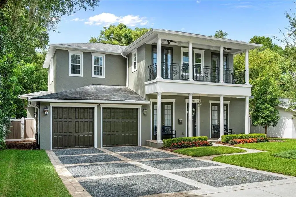 The design features large porches with ceiling fans and sweeping views.