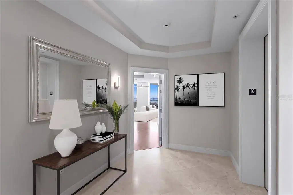 Virtually staged private entry foyer with two elevators.