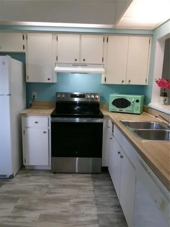 Clean Kitchen as you enter. New stove. Vinyl floor.