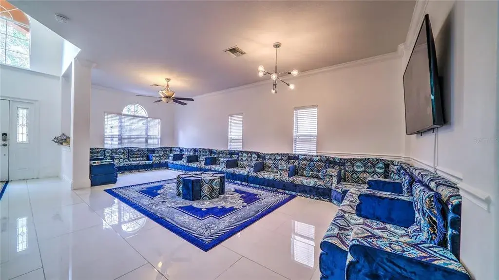 This living room is bright, spacious, and designed for both comfort and entertaining.