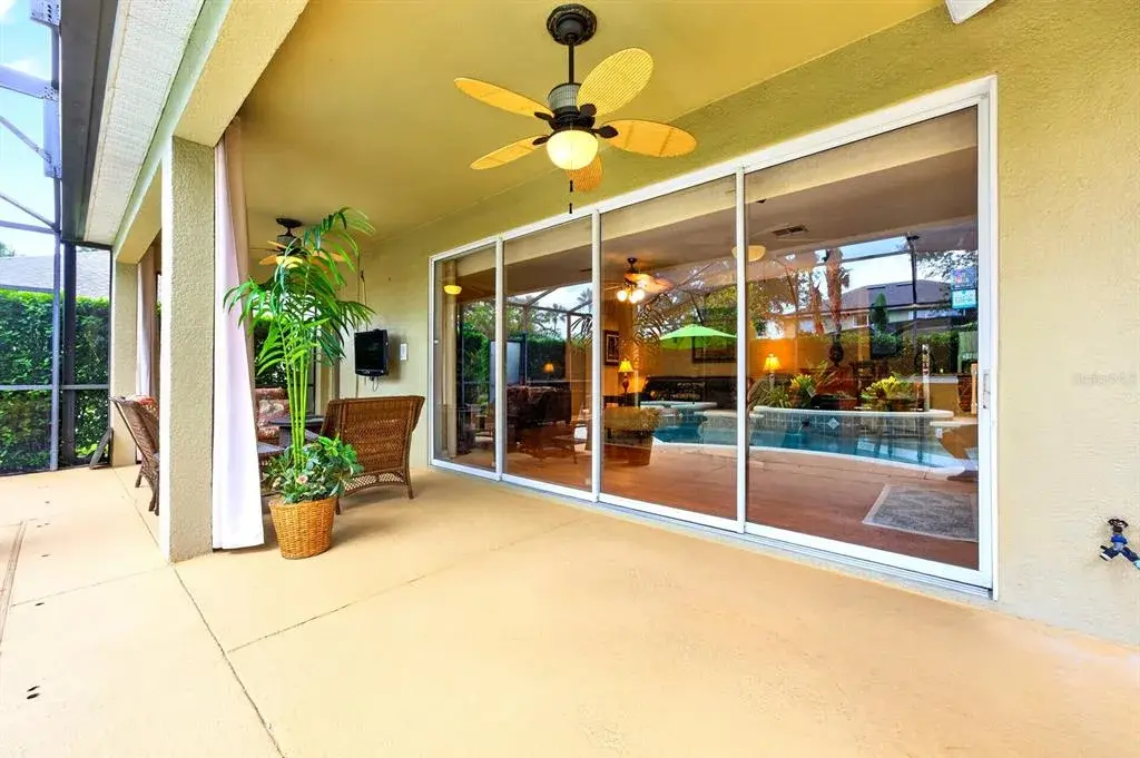The wall of sliding glass doors lets the natural light pour in and opens to deliver idyllic Florida living, complete with a private pool!