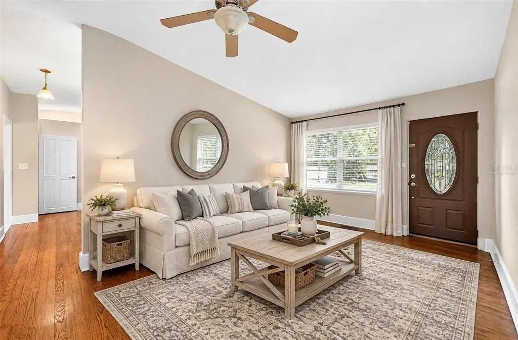 Formal living at the front of the home flows into the updated kitchen. Virtually Staged.