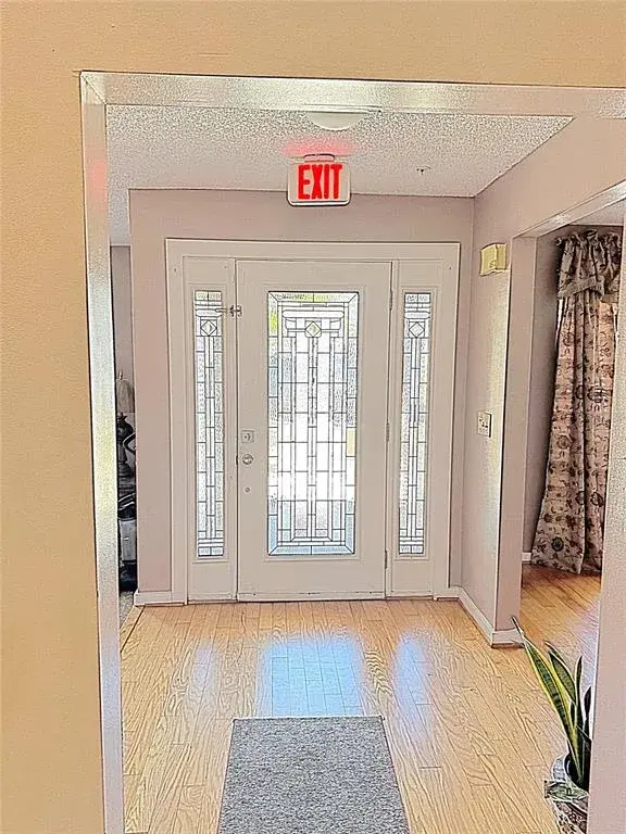 FOYER - FRONT ENTRY - DINING RM ON RT AND SUNKEN LIVING RM ON LEFT