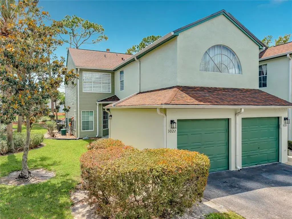 Condo entry is far back, while left side garage is the unit's garage.