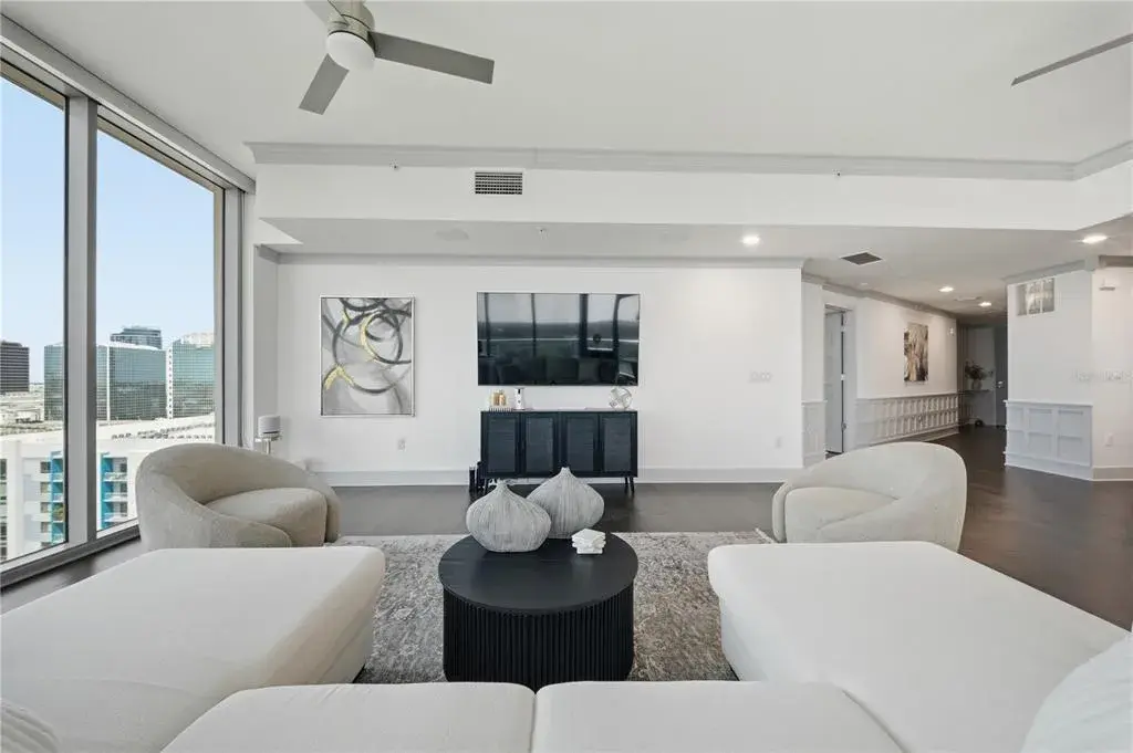 Generous wall space for media and art while preserving the corner-window experience
