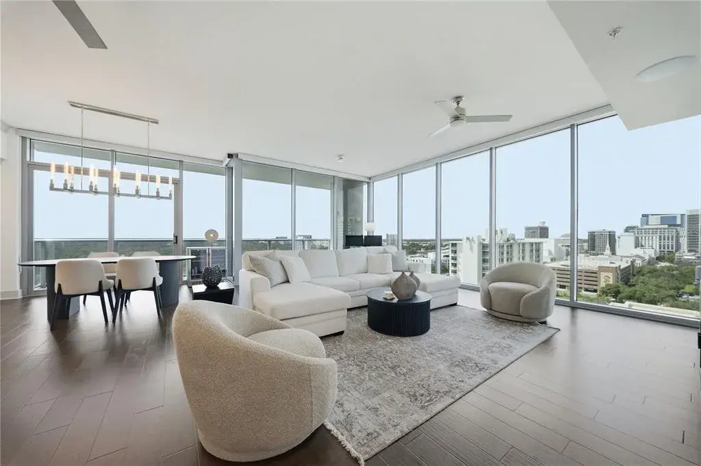 14th-Floor Corner Residence | Living and dining wrapped in 10-Foot Floor-to-Ceiling glass