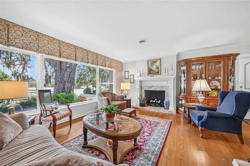 Living room with wood burning fireplace.