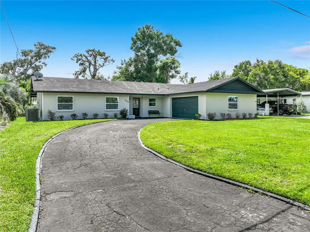 Welcome home—renovated Orlando living with a circular driveway and canal access.