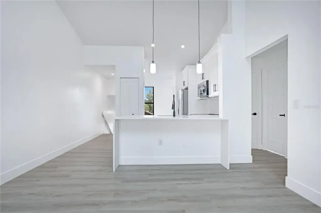 Open-concept living and dining area with fresh, modern finishes throughout.