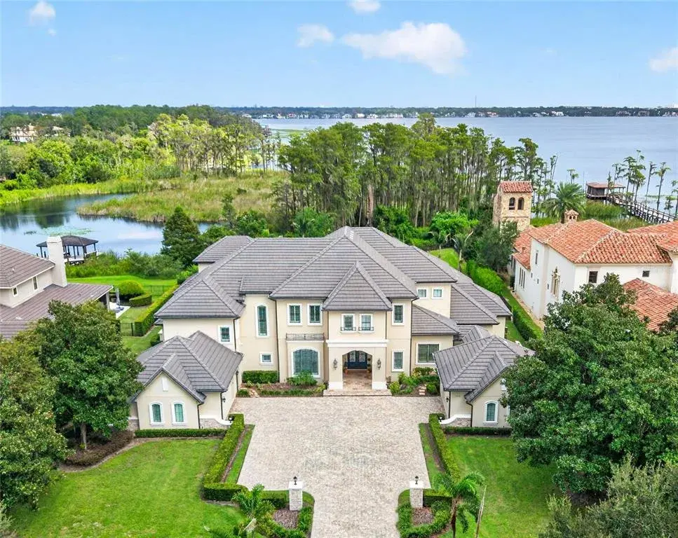 Exterior Aerial View- 6113 Grosvenor. Situated on oversized conservation 4.49 ACRE lot with 133 feet of Lake Tibet frontage.