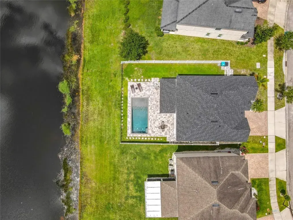 Enjoy a beautiful pool and outdoor kitchen with peaceful pond views—your own backyard retreat for fun, food, and sunsets!