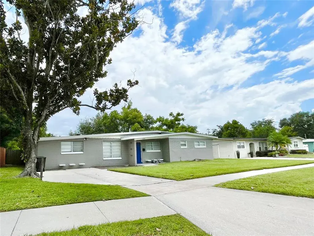Beautiful Mid Century Modern Home. 3/2 with 1741 sf on .25 Acre Lot Extra parking pad and sidewalks.
