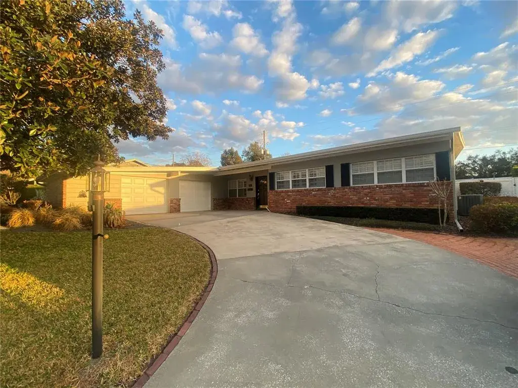 Front view. Paver drive and extra parking