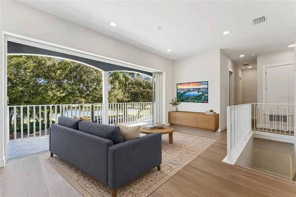 Virtually Staged - The loft offers natural light, recessed lighting, and a view of the staircase.