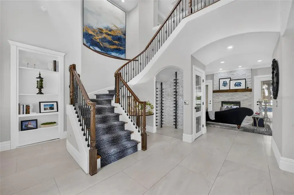 Two-story foyer with sweeping staircase and open sightlines into the main living spaces.