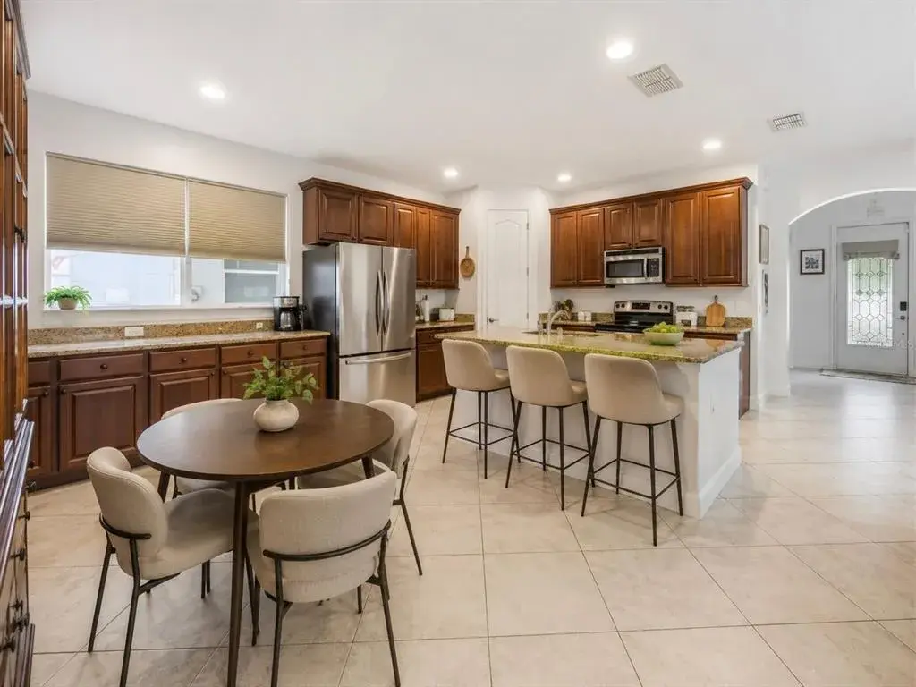 virtual staged open dining room, kitchen and family room