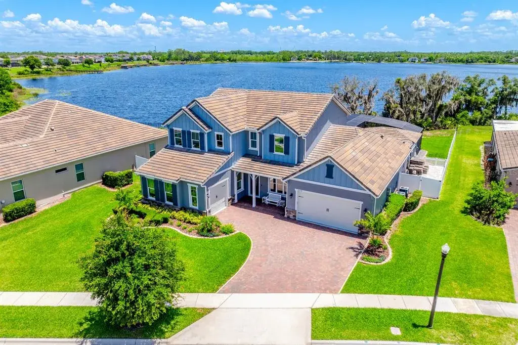 Experience LUXURY ~ WATERFRONT LIVING in this FULLY UPGRADED ~ POOL HOME in the sought-after Highlands at Summerlake Groves community of Horizon West!