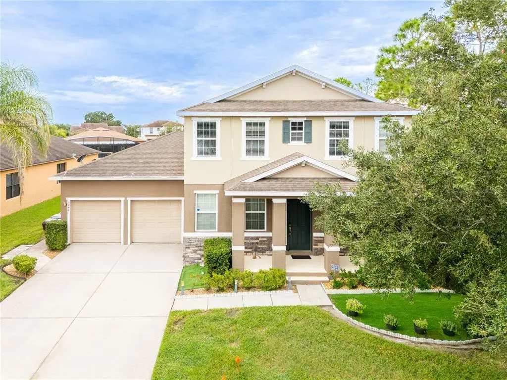 4-bedroom home for sale in Kissimmee, FL – front exterior with 2-car garage with two separate doors