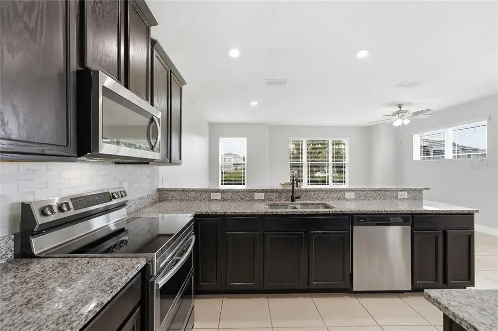 Open-concept kitchen overlooking the bright and spacious living area—perfect for entertaining.