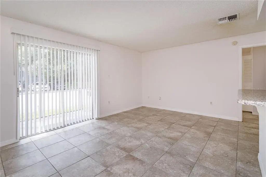 Living Room with Sliding Doors that open to the covered / screened in patio.
