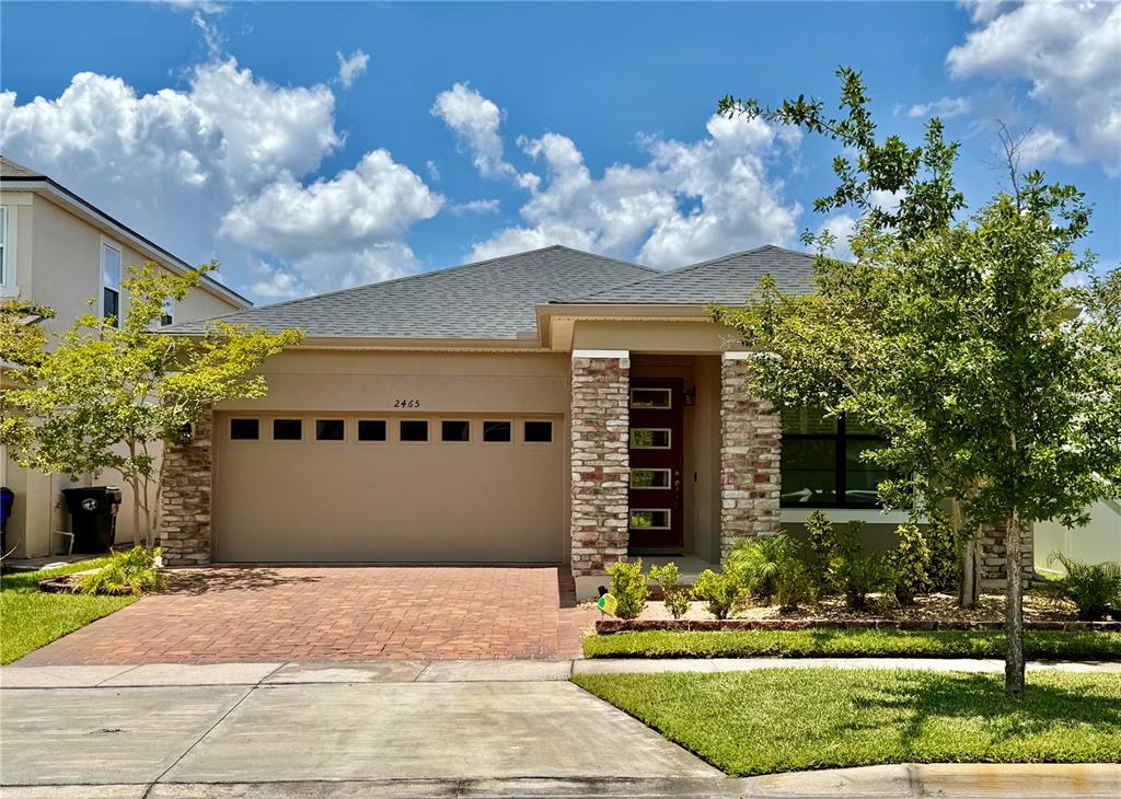 2465 Annacella Ave. – Beautiful stone-accented elevation with a paver driveway, covered front porch, and professionally landscaped curb appeal.